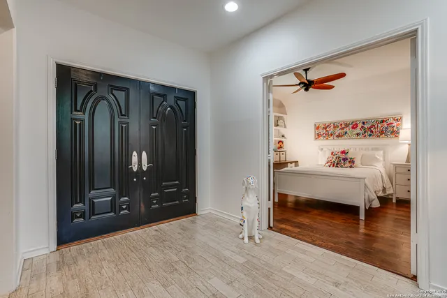 a bedroom with a bed and a mirror