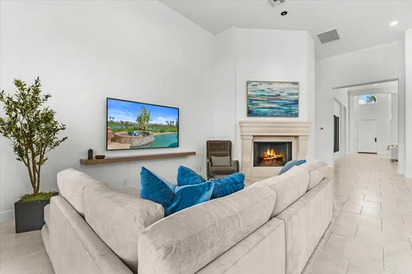 a living room with furniture and a fireplace