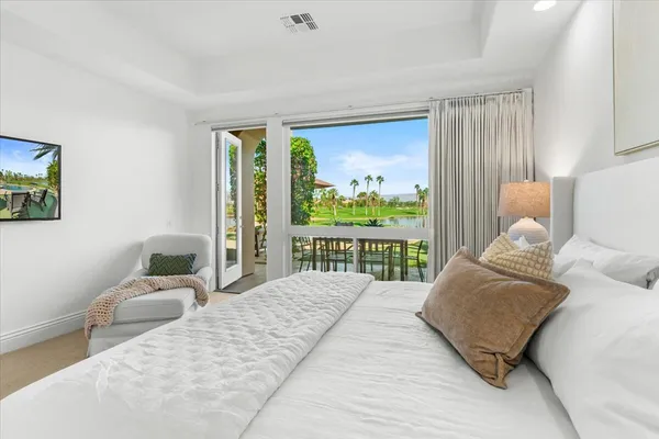 a bedroom with a large bed and a large window