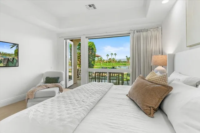 a bedroom with a large bed and a large window