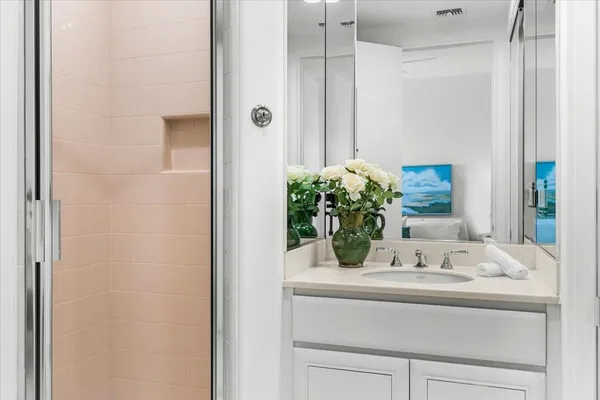 a bathroom with a granite countertop sink and a mirror