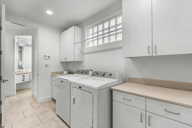 a view of a kitchen with cabinets appliances and a window