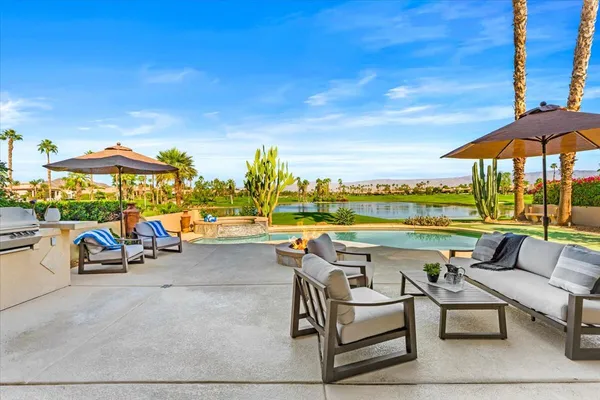 a view of swimming pool with outdoor seating space