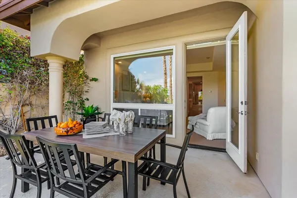 a outdoor dining space with furniture and wooden floor