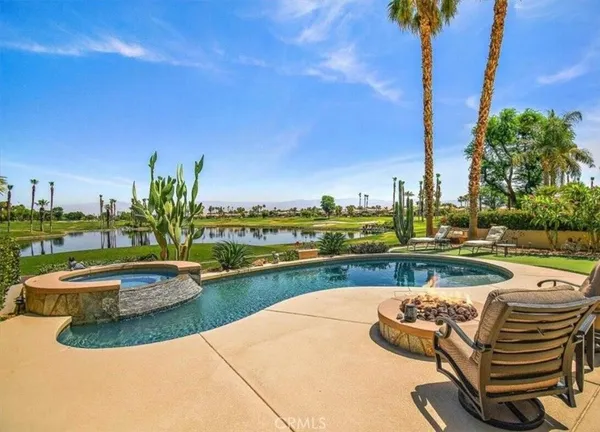 a view of swimming pool with outdoor seating and plants