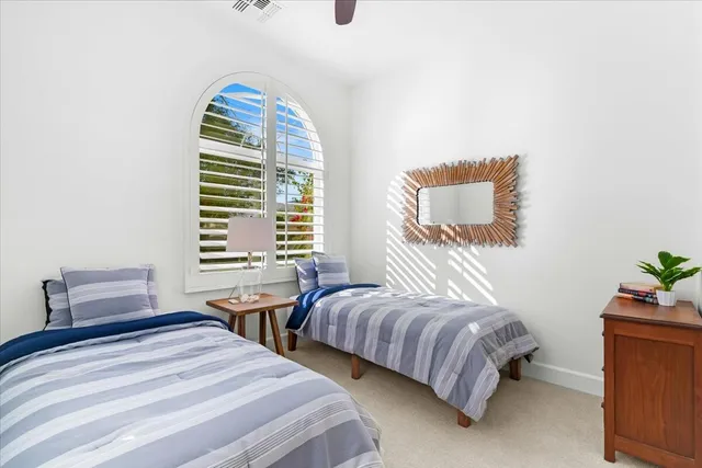 a bedroom with two beds and a window