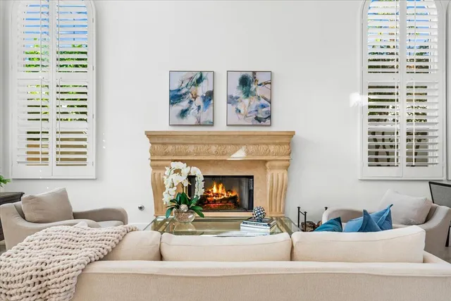 a living room with furniture and a fireplace
