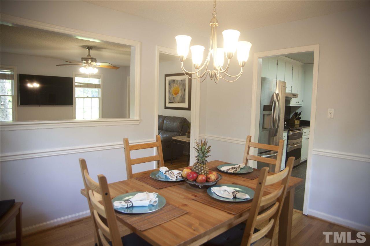 707 Torredge Road Durham, NC 27712 - Photo 3 of 21 a view of a dining room with furniture and wooden floor