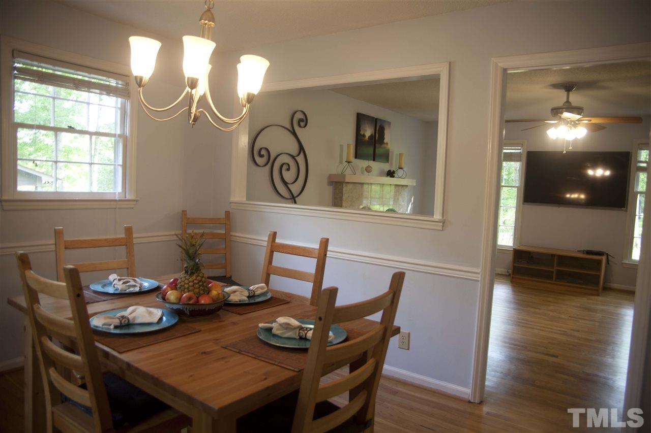 707 Torredge Road Durham, NC 27712 - Photo 4 of 21 a view of a dining room with furniture and wooden floor