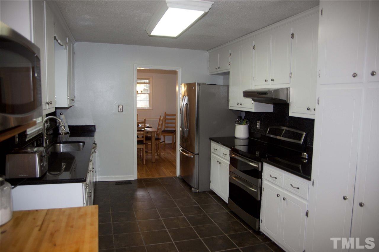 707 Torredge Road Durham, NC 27712 - Photo 5 of 21 a kitchen with a refrigerator and a stove