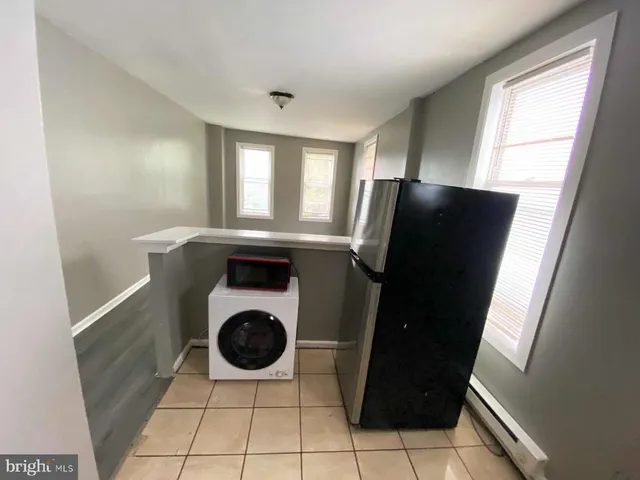 a kitchen with a refrigerator a washer and dryer