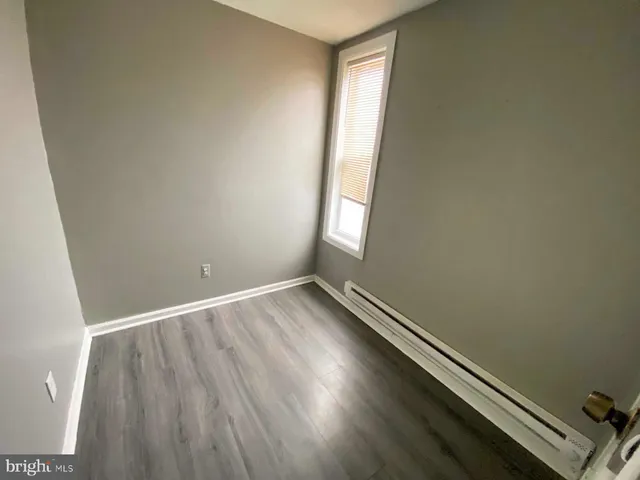 an empty room with wooden floor