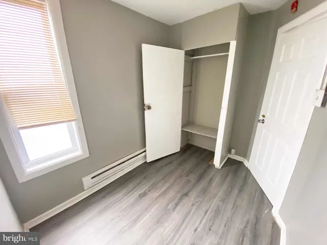 a view of a room with wooden floor and window