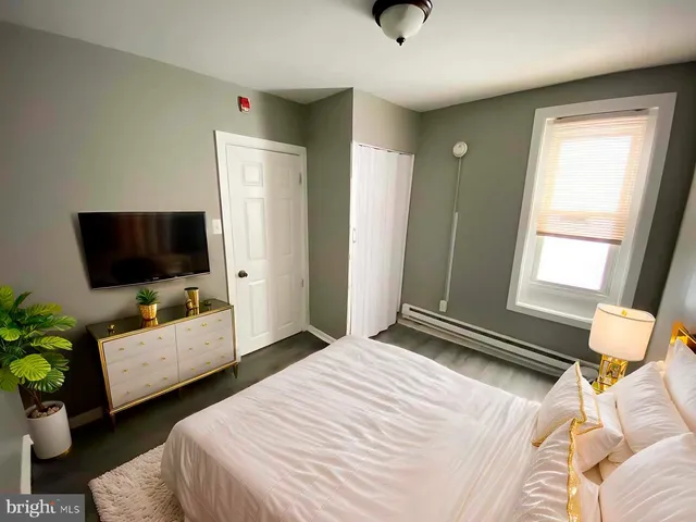 a bedroom with a bed and a flat screen tv