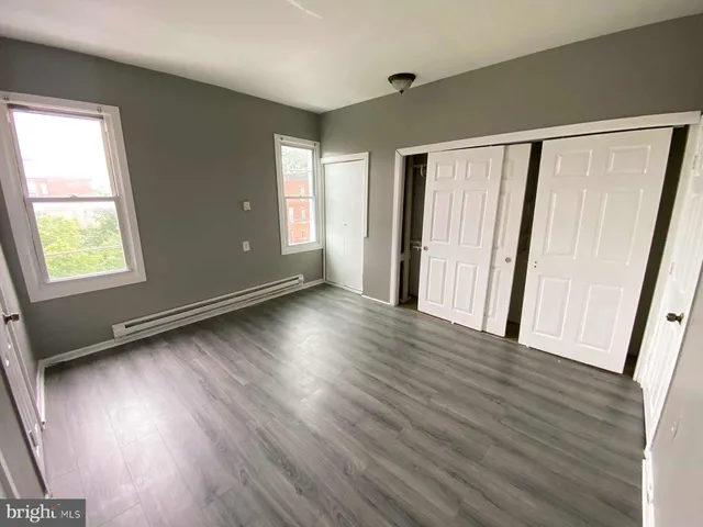 a view of a livingroom with wooden floor and window