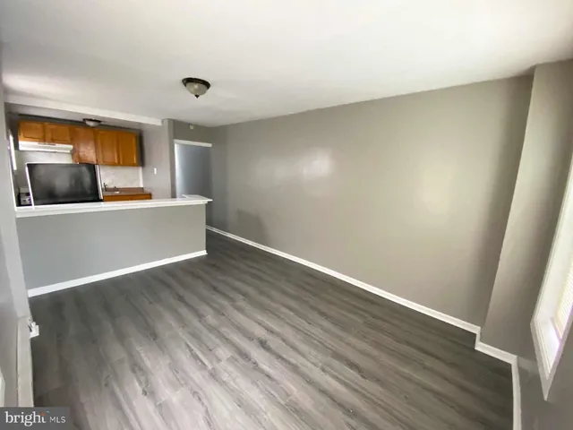 a view of a room with wooden floor and a sink