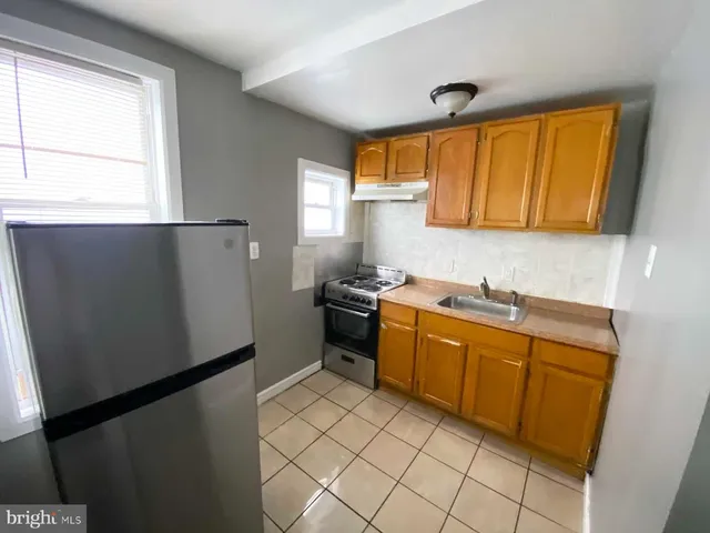 a kitchen with a refrigerator and a sink