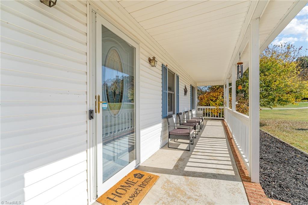 587 Lee Road Thomasville, NC 27360 - Photo 3 of 24 Front porch is spacious for several chairs for relaxing and just enjoying the fresh air!