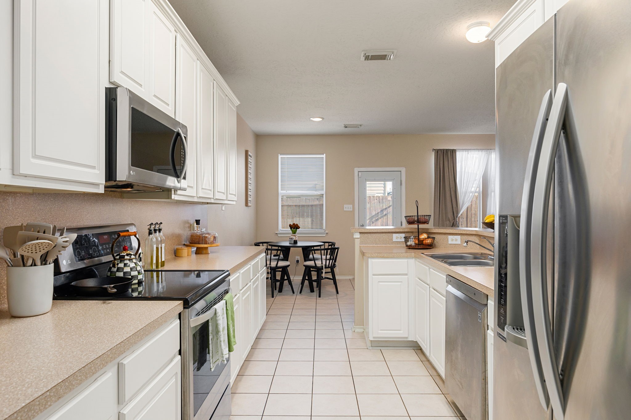 8917 Elm Drake Lane Humble, TX 77338 - Photo 10 of 25 a kitchen with a sink a stove top oven and cabinets