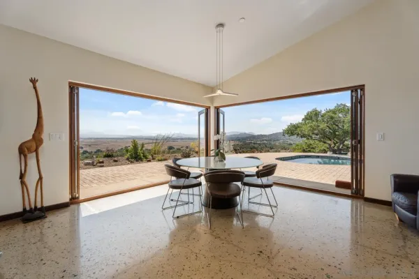 a kitchen with a dining table and chairs