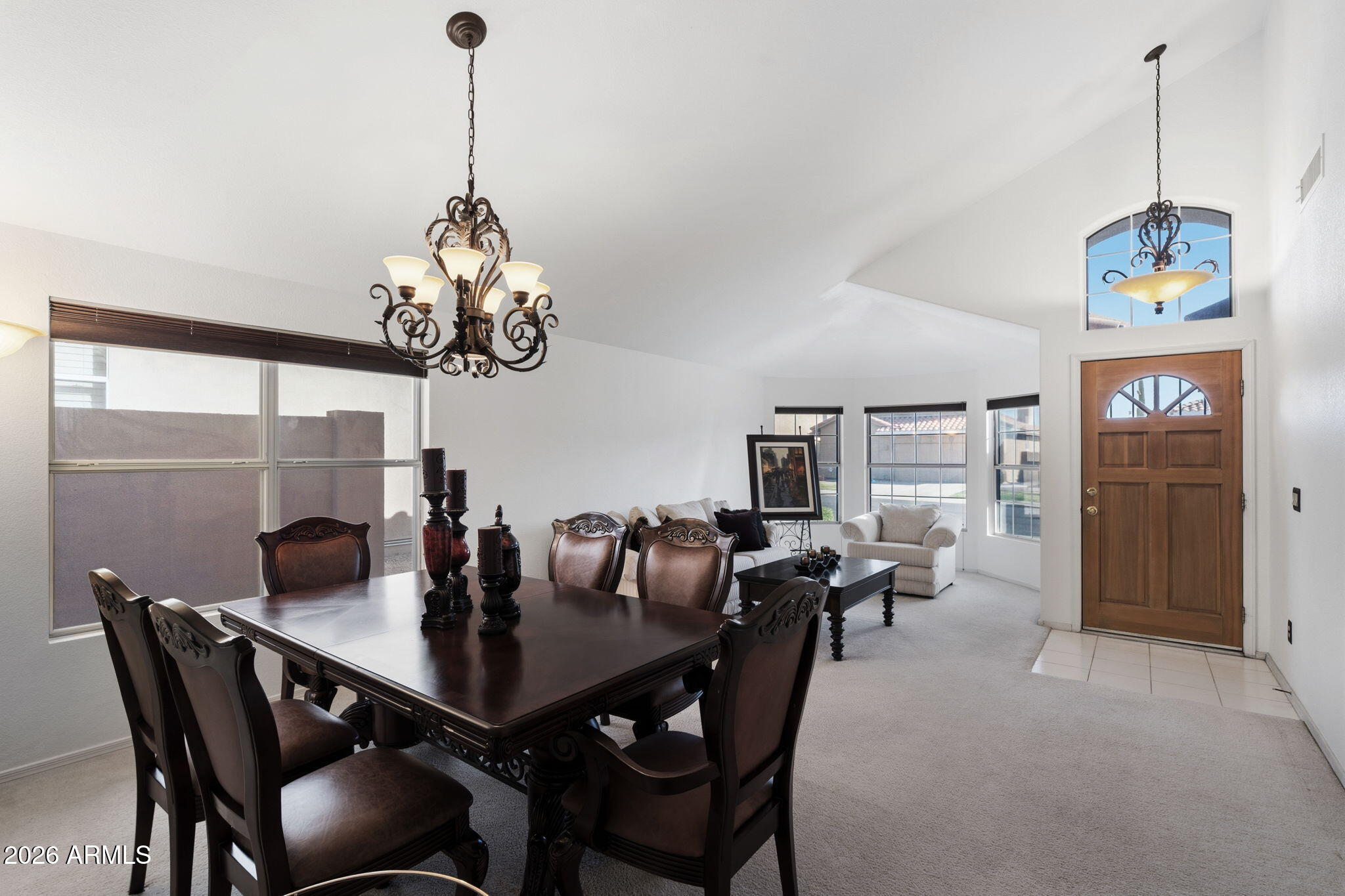 6526 East Raftriver Street Mesa, AZ 85215 - Photo 6 of 17 a dining room with furniture a chandelier and window