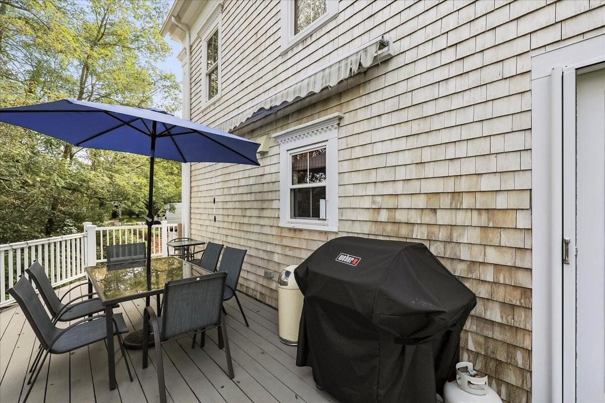 700 Samoset Road Eastham, MA 02642 - Photo 7 of 41 a view of a patio with a table and chairs under an umbrella