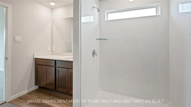 a bathroom with a shower and a sink