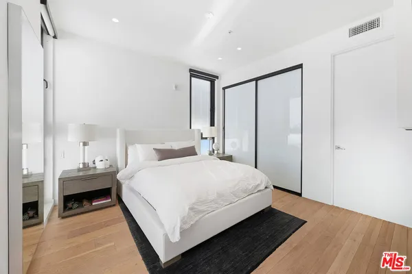 a bedroom with a bed and a table