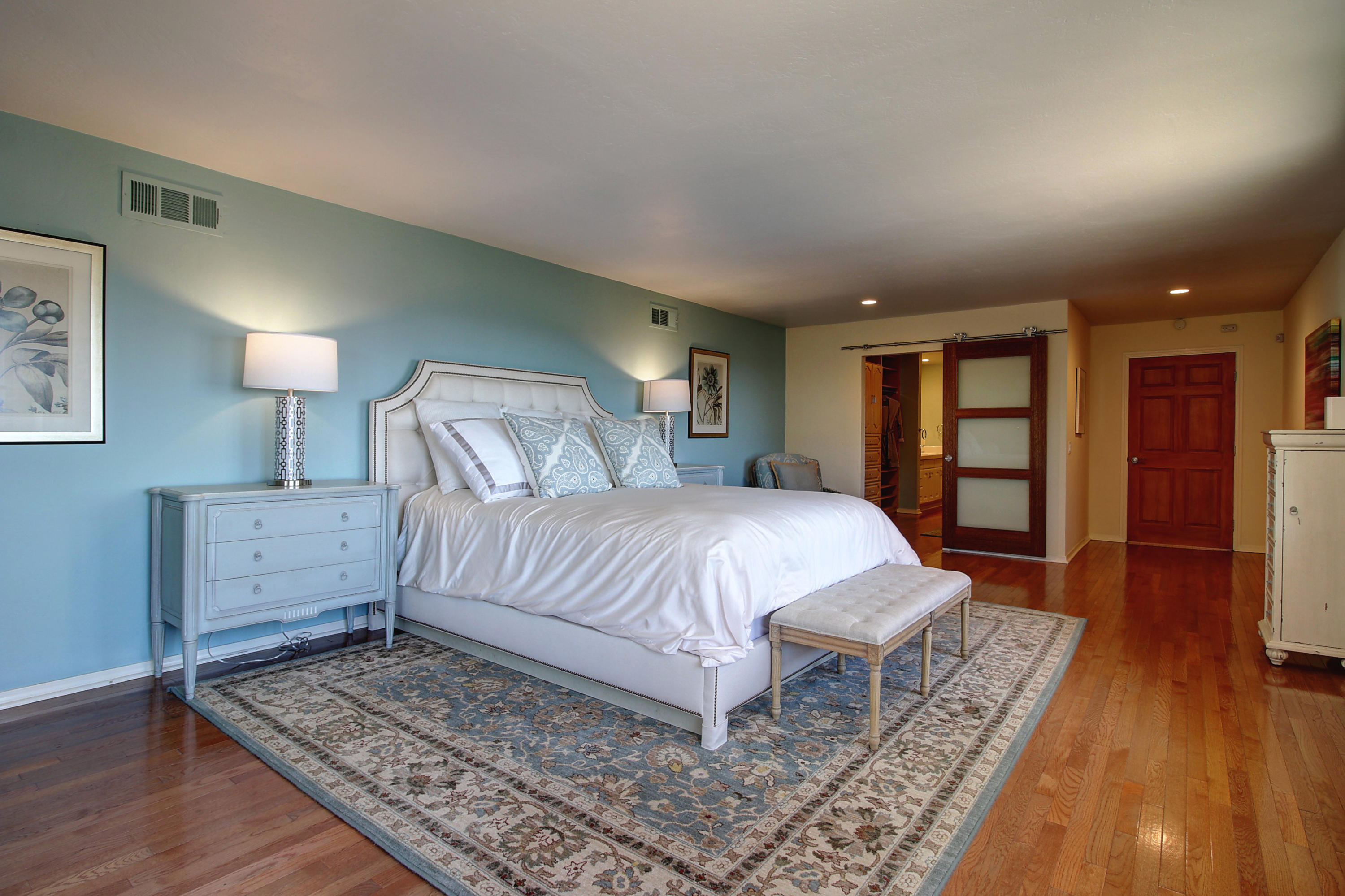1710 Mission Ridge Road Santa Barbara, CA 93103 - Photo 13 of 27 a spacious bedroom with a bed and wooden floor