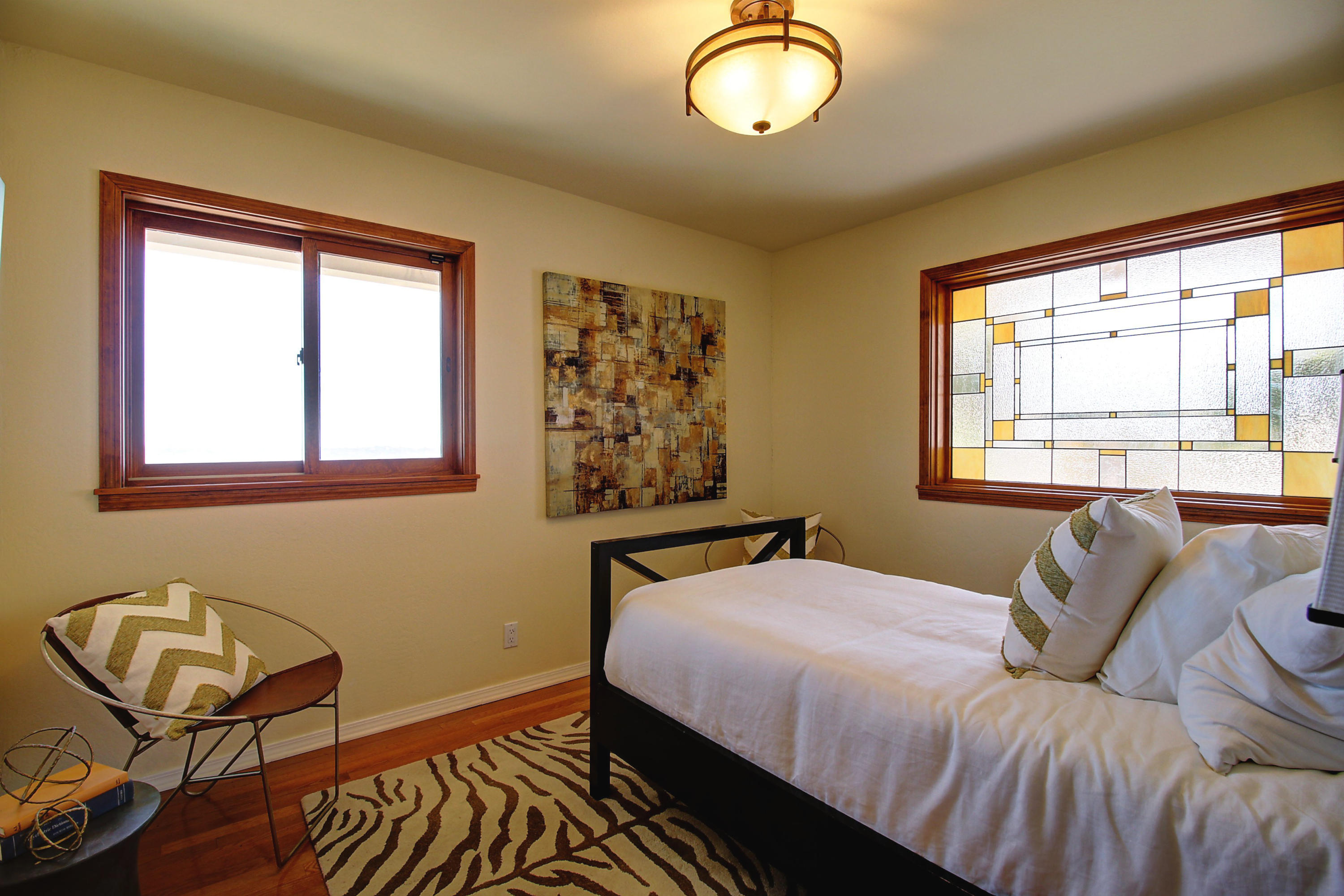1710 Mission Ridge Road Santa Barbara, CA 93103 - Photo 16 of 27 a bedroom with a bed and wooden floor