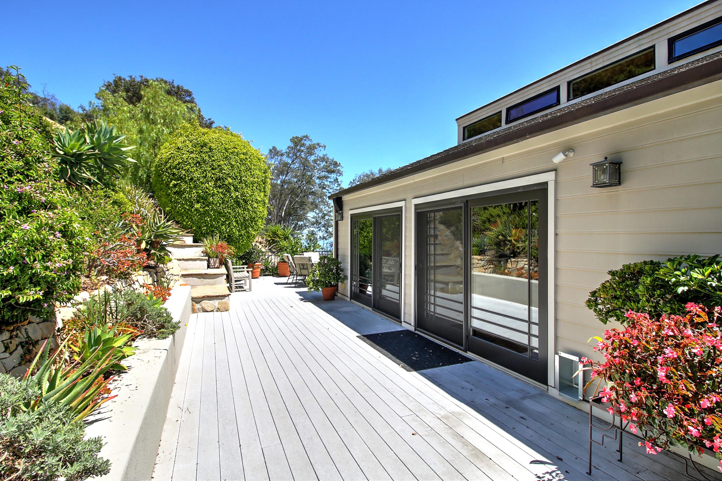 1710 Mission Ridge Road Santa Barbara, CA 93103 - Photo 21 of 27 a house with wooden floor and potted plants