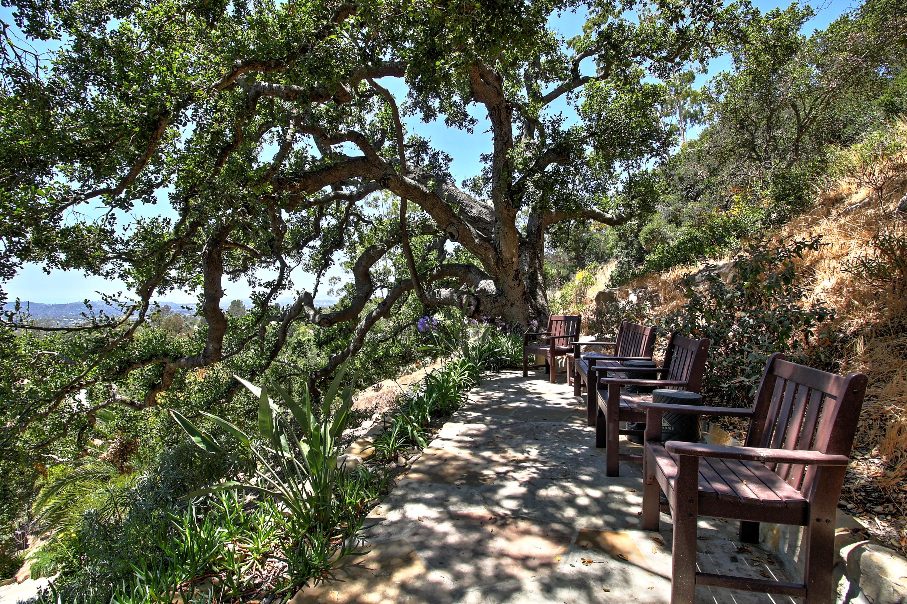 1710 Mission Ridge Road Santa Barbara, CA 93103 - Photo 23 of 27 a view of a patio with table and chairs with wooden fence and plants