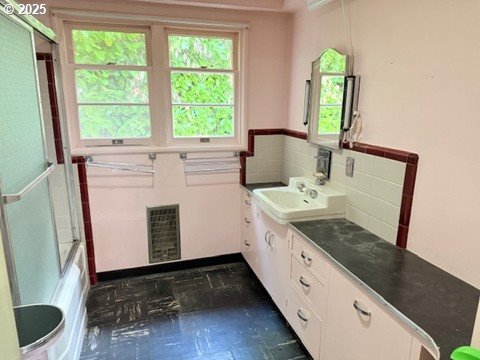 2010 East 26th Avenue Eugene, OR 97403 - Photo 3 of 12 a bathroom with a sink a toilet and a mirror