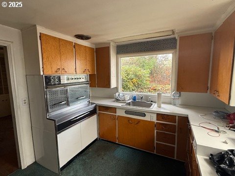 2010 East 26th Avenue Eugene, OR 97403 - Photo 7 of 12 a kitchen with stainless steel appliances a sink stove and cabinets