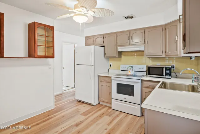a kitchen with a white cabinets and white appliances