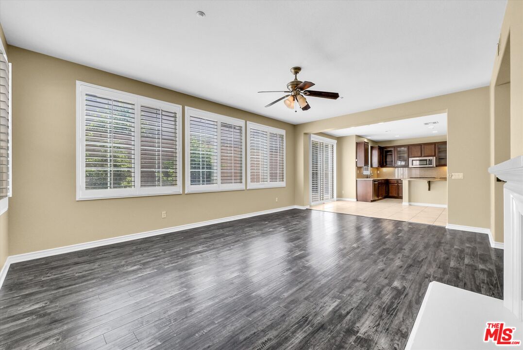 5611 Scharf Avenue Fontana, CA 92336 - Photo 11 of 49 a view of an empty room with a window and wooden floor
