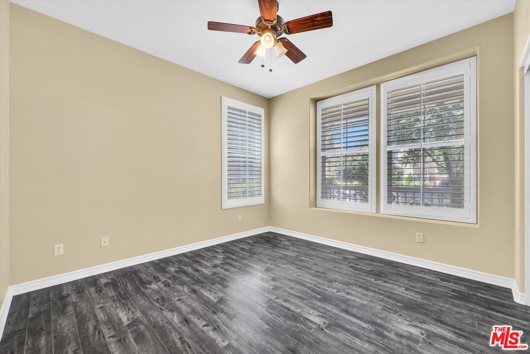 5611 Scharf Avenue Fontana, CA 92336 - Photo 19 of 49 a view of wooden floor and windows in a room