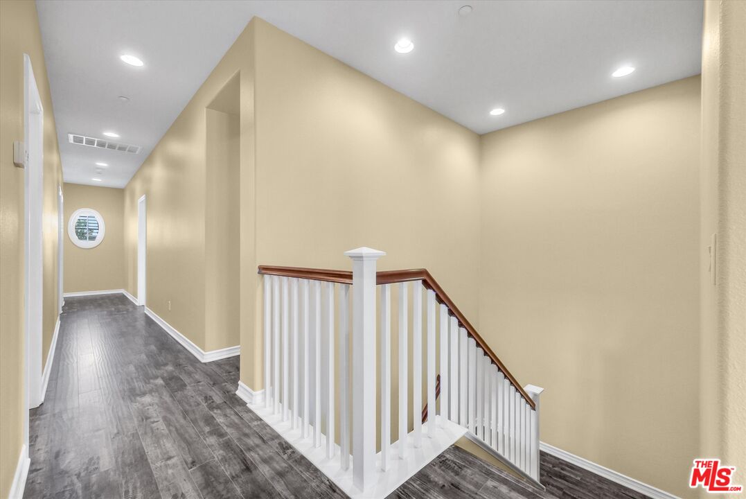 5611 Scharf Avenue Fontana, CA 92336 - Photo 28 of 49 a view of a hallway with wooden floor