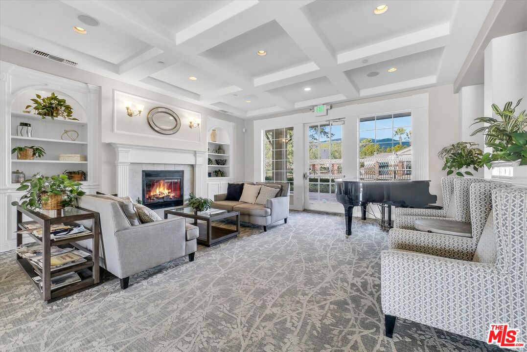 5611 Scharf Avenue Fontana, CA 92336 - Photo 43 of 49 a living room with furniture a fireplace and a potted plant