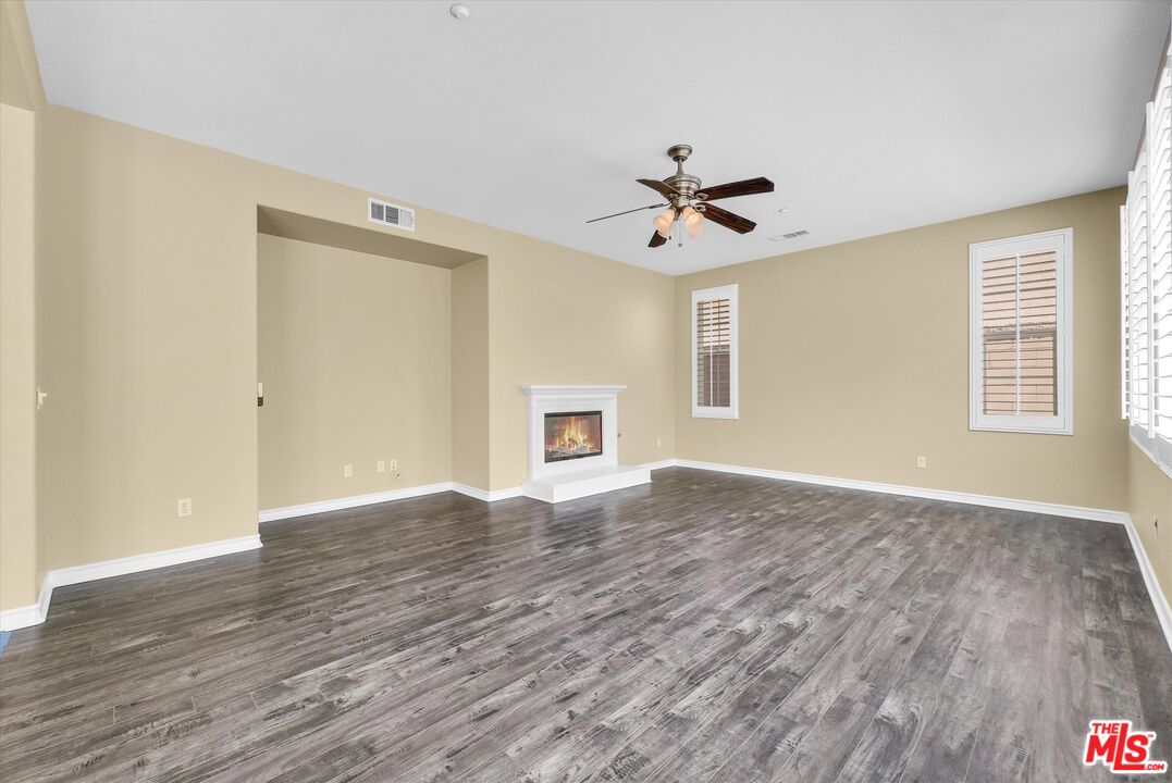 5611 Scharf Avenue Fontana, CA 92336 - Photo 10 of 49 a view of empty room with wooden floor and fan