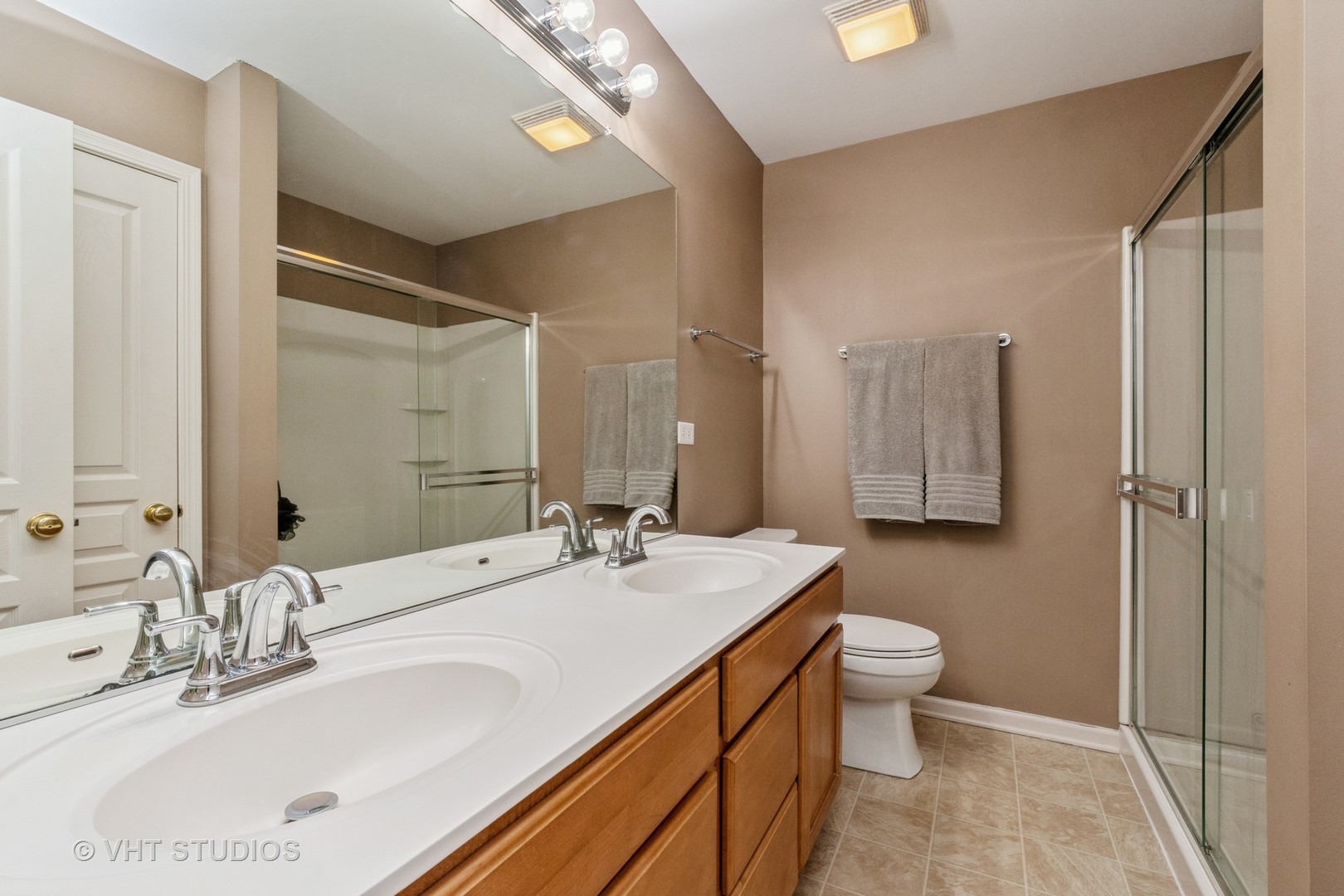 15320 Pinewood Road Lockport, IL 60441 - Photo 16 of 22 a bathroom with a double vanity sink toilet and mirror