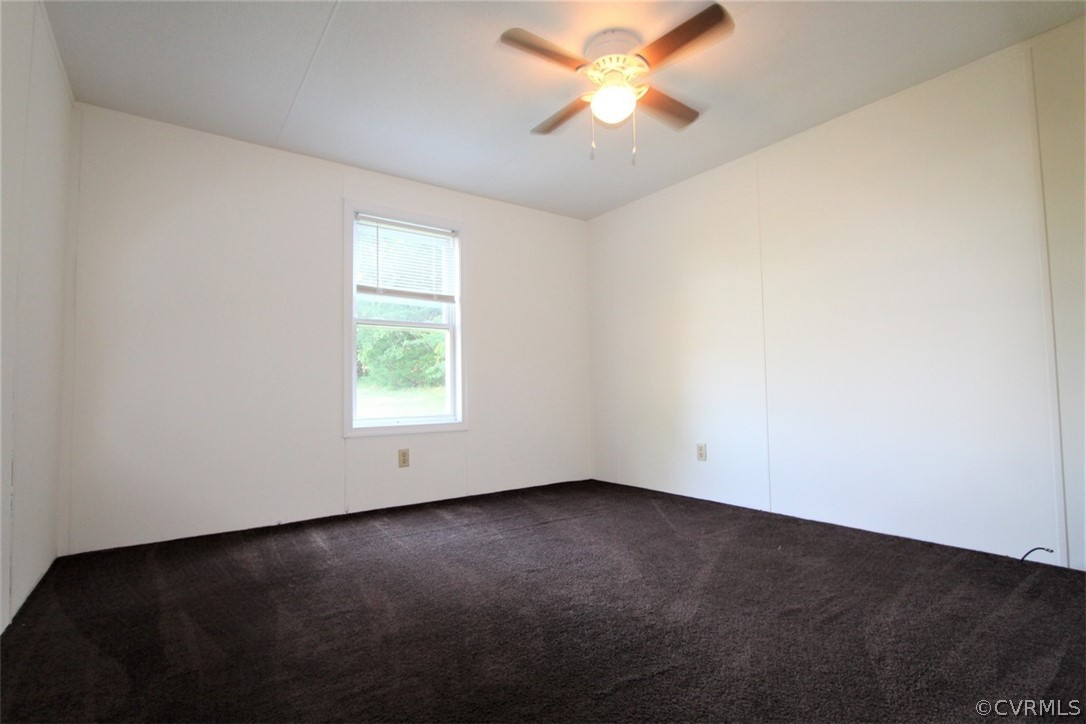 1400 River Road Farmville, VA 23901 - Photo 20 of 29 an empty room with a window and a ceiling fan