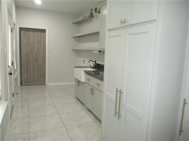 a kitchen with white cabinets and white appliances
