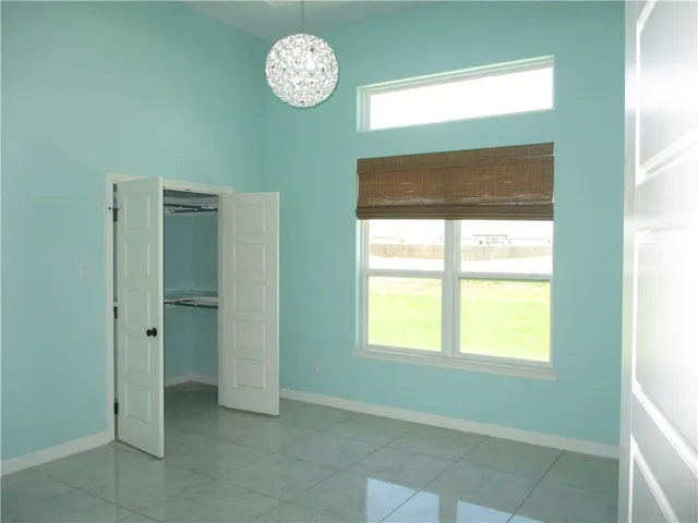 a view of a room that has a window and a closet