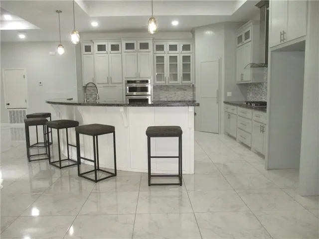 a kitchen with stainless steel appliances granite countertop a sink and cabinets