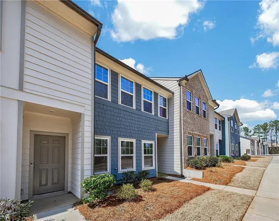 a front view of brick house with a yard