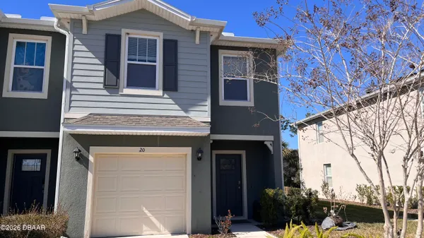 a view of a house with a door and wooden walls