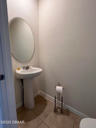 a bathroom with a sink toilet and a mirror