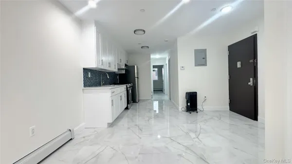 a bathroom with a sink and mirror with bathtub