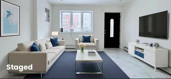 a living room with furniture and a flat screen tv